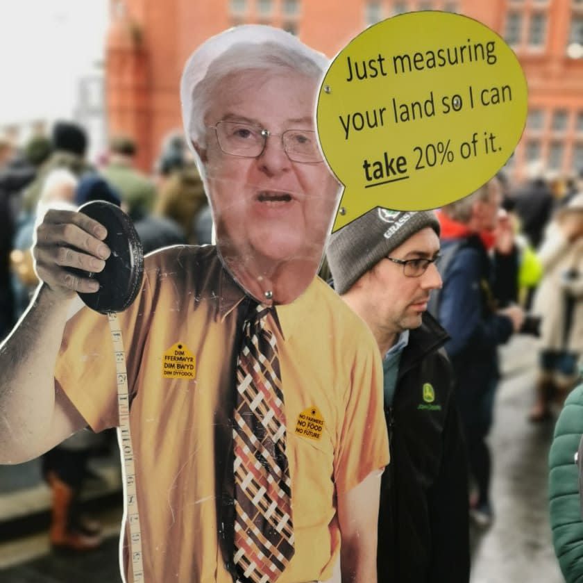 A cut-out of Mark Drakeford, Welsh First Minister, with the slogan 'Just measure your land so I can take 20 per cent of it' is seen at the protest