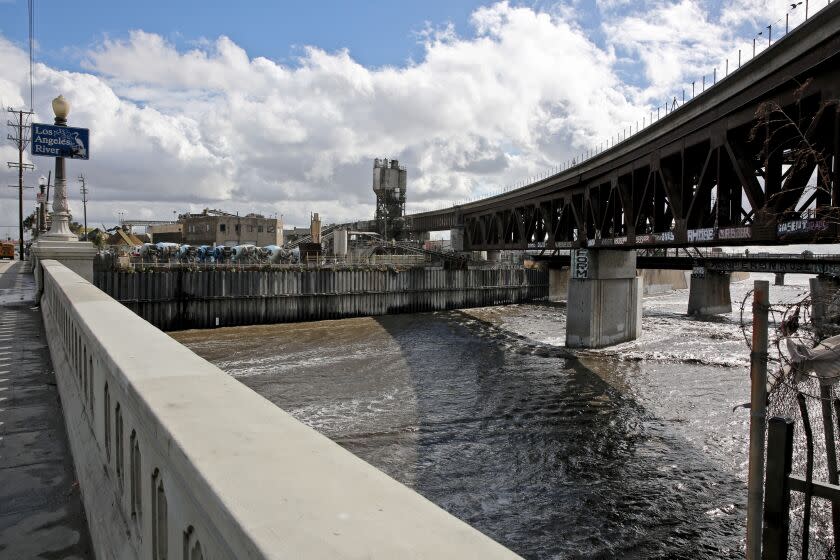 The Los Angeles River carries a large amount of storm run-off as it flows south under the Washington Blvd. bridge, in Los Angeles on Tuesday, Nov. 8, 2022. Two vehicles were reported in the water earlier in the day.