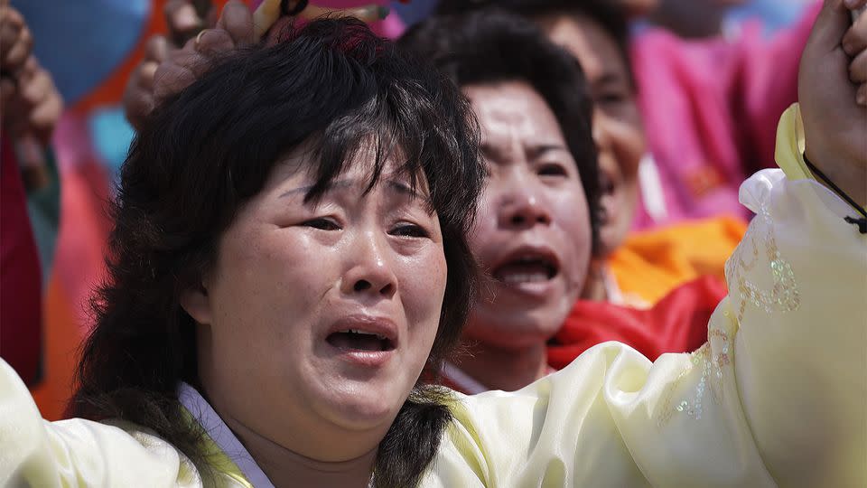 North Korean women cry as they march past leader Kim Jong-un. Source: AP