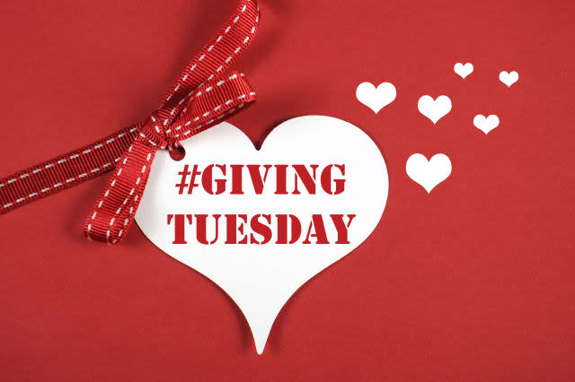 Giving Tuesday philanthropy day after Black Friday shopping message sign white heart on red background and sample text.