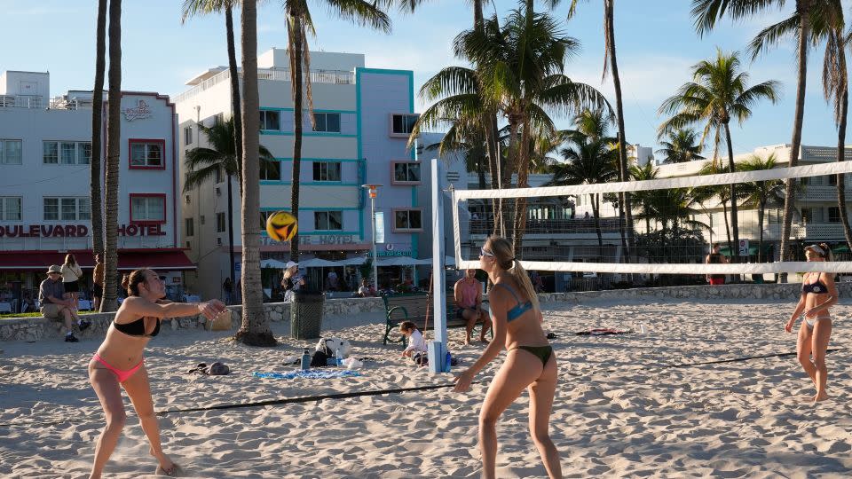 Beachgoers play volleyball along Ocean Drive in Miami Beach on February 27. - Marta Lavandier/AP