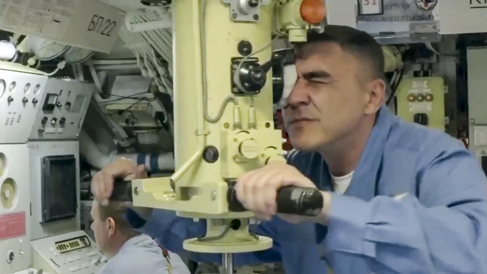 In this undated video grab provided by Russian Defense Ministry Press Service, A Russian submariner looks in periscope during a naval exercise in the Bering Sea. The Russian navy has conducted massive war games near Alaska involving dozens of ships and aircraft, the biggest such drills in the area since Soviet times. (Russian Defense Ministry Press Service via AP)