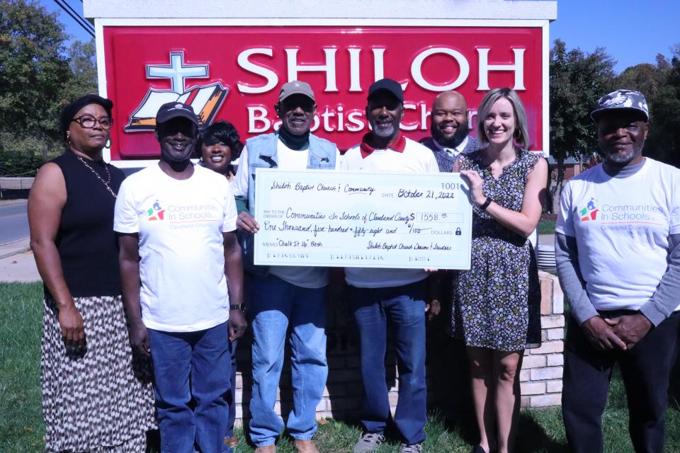 Shiloh Baptist Church leaders present a check to Communities In Schools of Cleveland County. Pictured (from left) are Angie Bell, Joseph Finney, Latosha Lawrence,  Jerry Mitchell, Fred Mitchell, Pastor Jamaal Edwards, Heather Bridges Moore and Wayne Howell.
