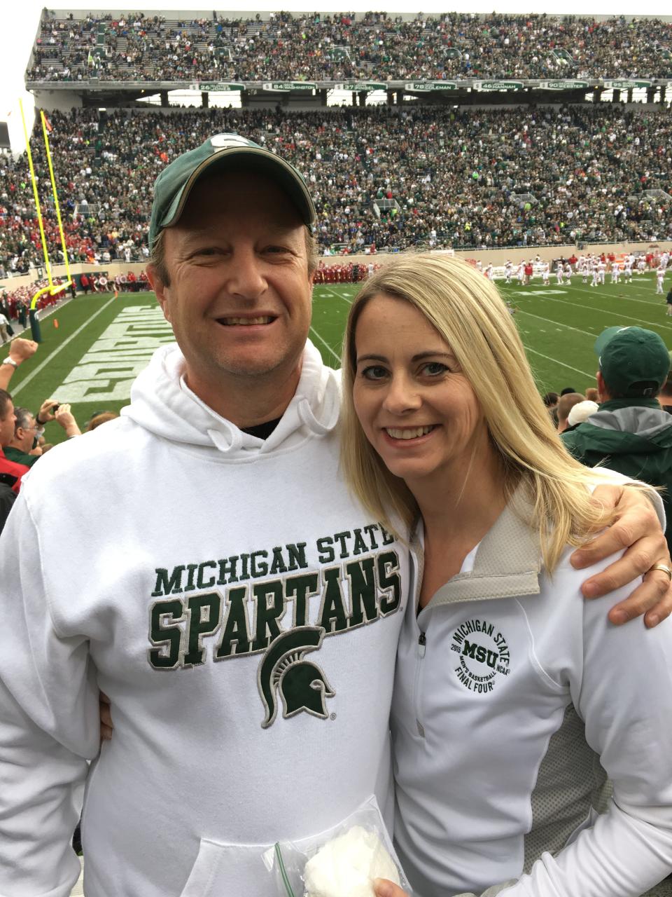 Professors Tina Timm and Adrian Blow at a Michigan State football game.