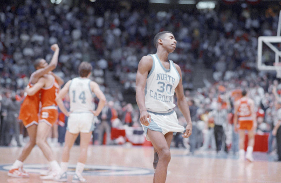 North Carolina’s Kenny Smith, right, walks off the court leaving celebrating Syracuse Orangemen Derrick Coleman, left, and Rony Seikaly to their moment. Syracuse beat North Carolina 79-75 in the NCAA East Regional Final, March 21, 1987, in East Rutherford. AP Photo/Ray Stubblebine