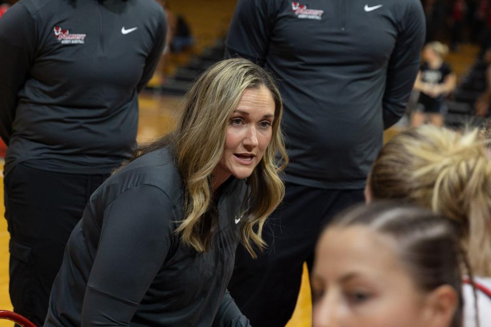 Erin Doughty huddles her Marist College players to talk strategy during a timeout against Army in a Nov. 9, 2023 women's basketball game.