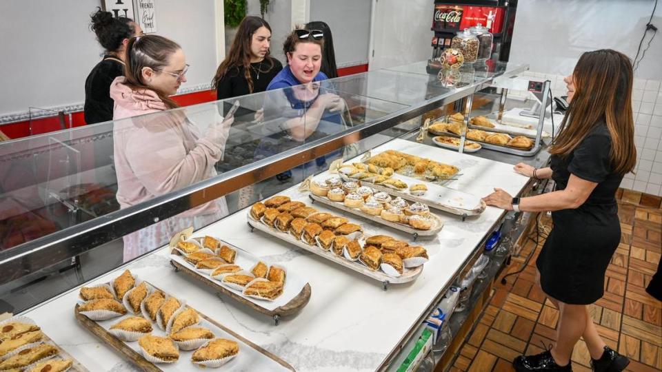 Karine Sahakyan, right, assists customers with choices of baklava at Baklava House, now open on Bullard Avenue near West Avenue in Fresno. The new restaurant also offers breakfast, lunch and dinner.