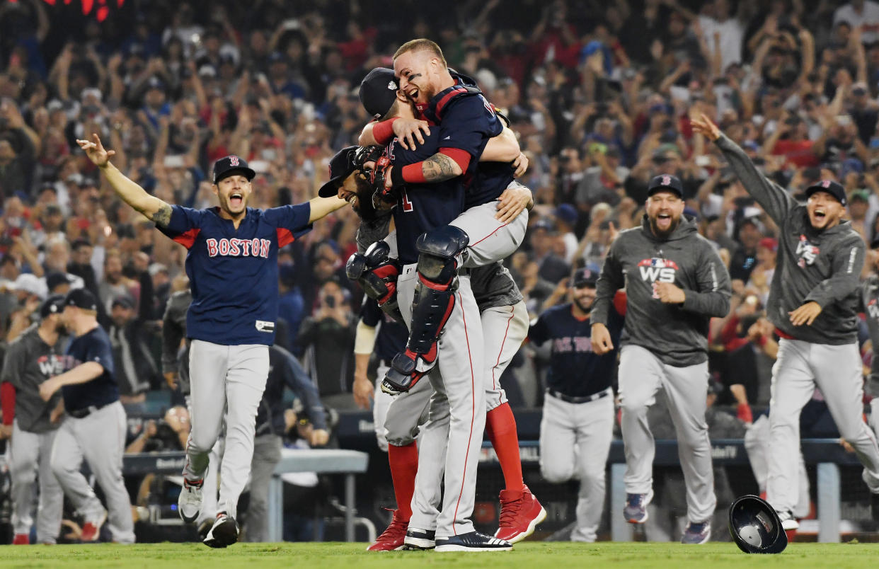 Christian Vazquez jumps into the arms of Chris Sale of the Boston Red Sox to celebrate their 5-1 win over the Los Angeles Dodgers in Game Five to win the 2018 World Series. (Getty)