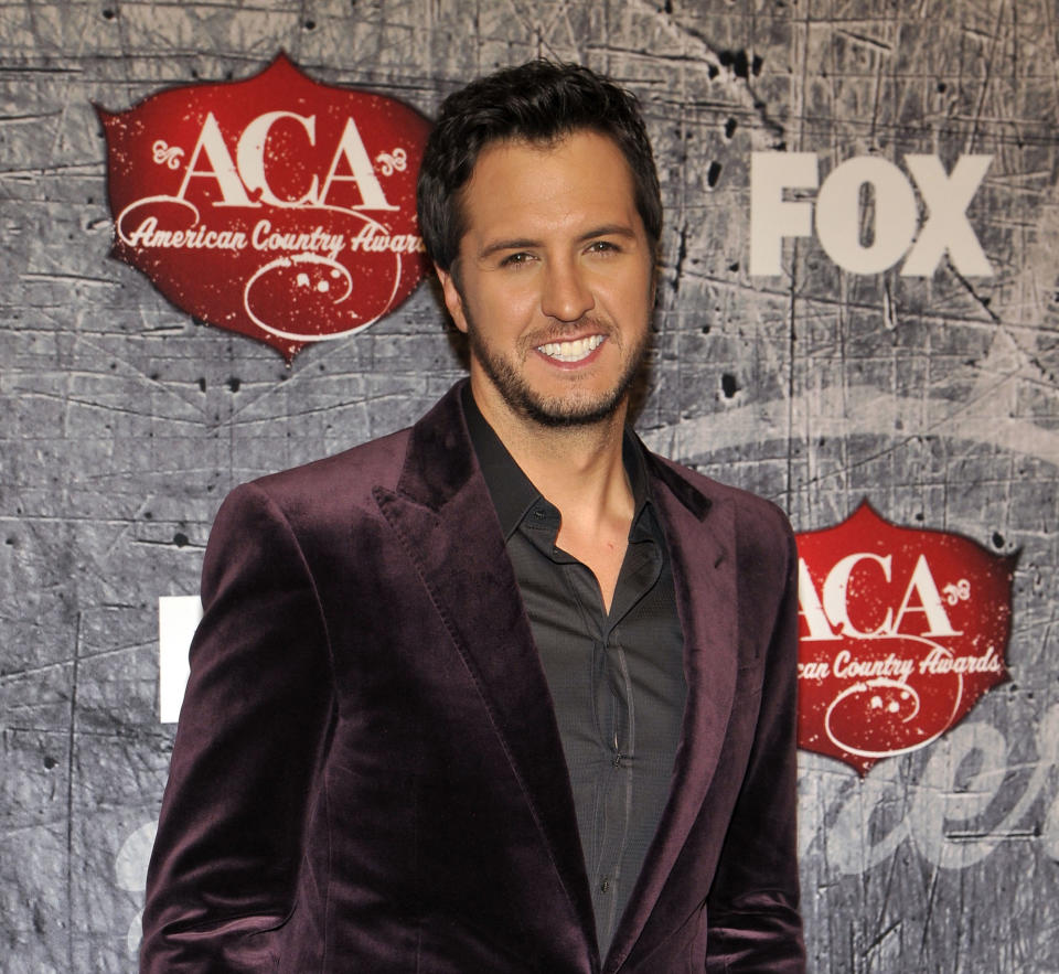 FILE - In this December 10, 2012, singer Luke Bryan arrives at the American Country Awards in Las Vegas. Co-hosts Blake Shelton and Luke Bryan also will perform during this year's Academy of Country Music Awards airing live on April 7, 2013 on CBS. The country cut-ups are among the first round of performers announced Wednesday, March 6, 2013, for the Las Vegas annual awards show and will be joined by Shelton's wife, Miranda Lambert, George Strait, Kelly Clarkson, Hunter Hayes and The Band Perry. (Photo by Jeff Bottari/Invision/AP, File)