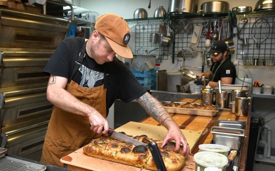 Chef/owner Terrence Daley works in the kitchen at The Daley Trade, a wine bar and restaurant in downtown Titusville. Daley and his wife Laura are business partners in this eclectic dining establishment that serves an ever-changing menu of dishes inspired by fresh ingredients.