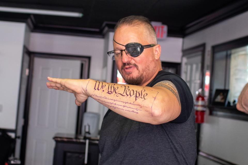 Oath Keepers President Stewart Rhodes shows off a new tattoo at the Casa Di Dolore Tattoo shop in Newburgh, NY on June 2, 2020. 