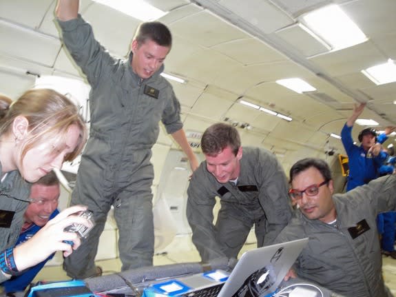 Student engineers Daneesha Kenyon (left), Jack Goodwin (center) and Sam Avery (center right) with the UCSD Microgravity Team study biofuel fires in weightlessness during NASA Microgravity University flight on a ZERO-G flight based out of Elling