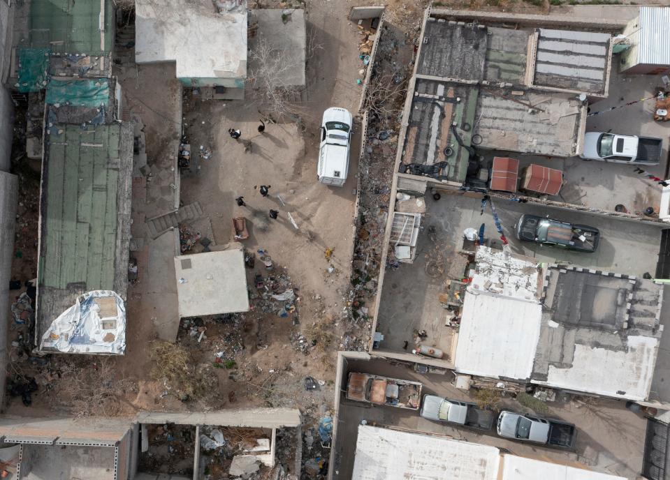 The remains of two unidentified persons are removed by Mexican coroner officials from a home during a search for possibility of dozens of more bodies buried in a suspected narco grave at a home just south of the international border in Juárez.