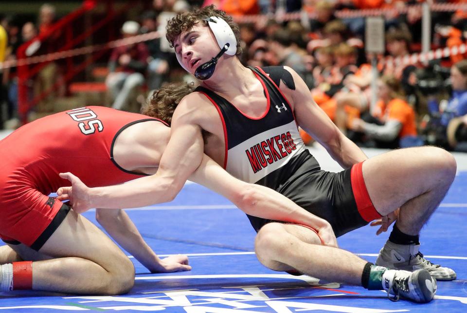 Muskego’s Ryker Morgan reaches around Wisconsin Rapids Lincoln’s Cooper Meyer in a 175-pound match during a Division 1 semifinal dual.