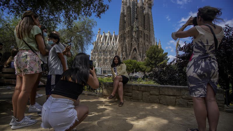 People take pictures in front of Sagrada Familia Basilica designed by architect Antoni Gaudi in Barcelona, Spain, on Friday, July 9, 2021.