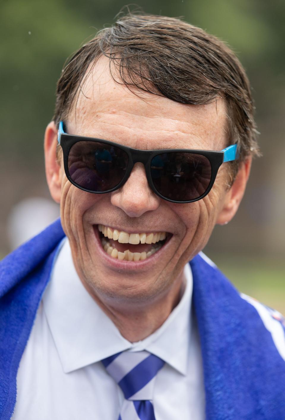 University of Memphis President Bill Hardgrave laughs as he gives an interview after running through the campus fountain Monday, Aug. 22, 2022, at the University of Memphis. 