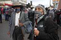 Men stand on the Inter American Highway as part of a crowd blocking it during a nationwide strike in Totonicapan, Guatemala, early Thursday, July 29, 2021. People are calling for the resignation of Guatemalan President Alejandro Giammattei and Attorney General Consuelo Porras after they fired Special Prosecutor Against Impunity Juan Francisco Sandoval. (AP Photo/Moises Castillo)