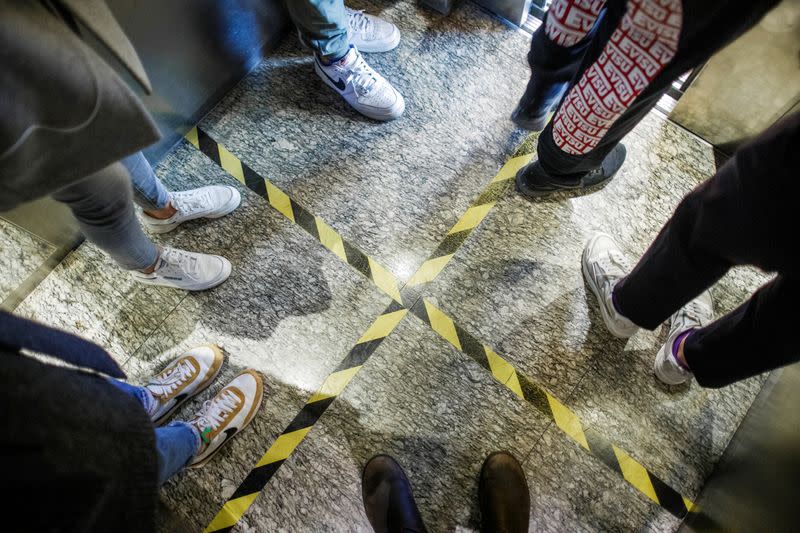 Lines serving as a guide for social distancing are seen in a lift in a department store in Beijing