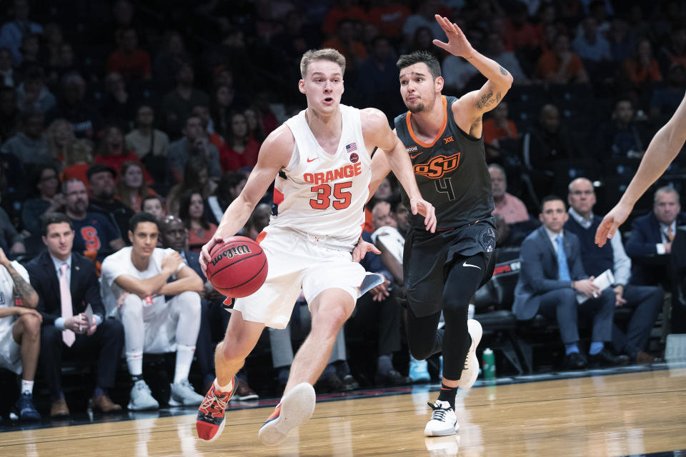 Syracuse guard Buddy Boeheim (35) drives against Oklahoma State guard Thomas Dziagwa (4) during the second half of an NCAA college semi final basketball game in the NIT Season Tip-Off tournament, Wednesday, Nov. 27, 2019, in New York. Oklahoma State won 86-72. (AP Photo/Mary Altaffer)