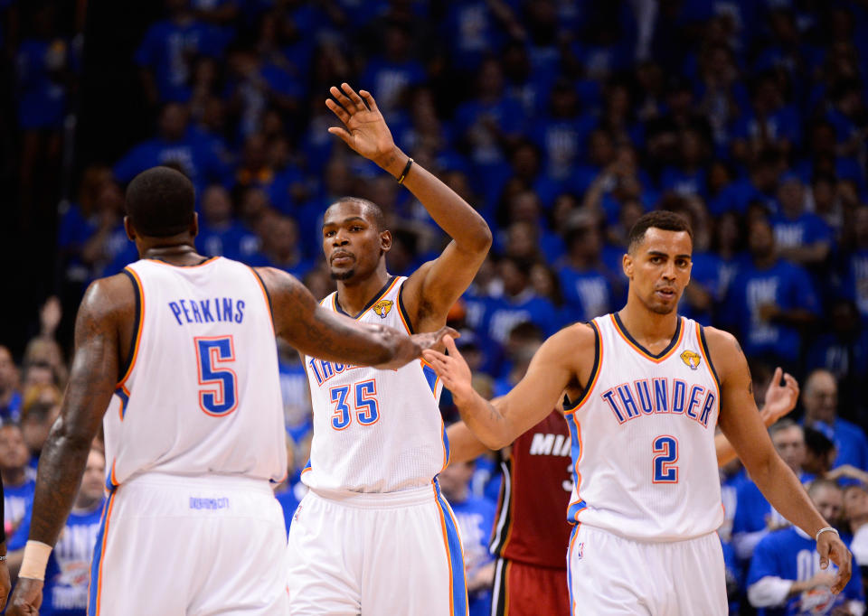 Thabo Sefolosha, Kevin Durant and Kendrick Perkins of the Oklahoma City Thunder celebrate a play in the third quarter while taking on the Miami Heat in Game One of the 2012 NBA Finals at Chesapeake Energy Arena on June 12, 2012 in Oklahoma City, Oklahoma. (Photo by Ronald Martinez/Getty Images)