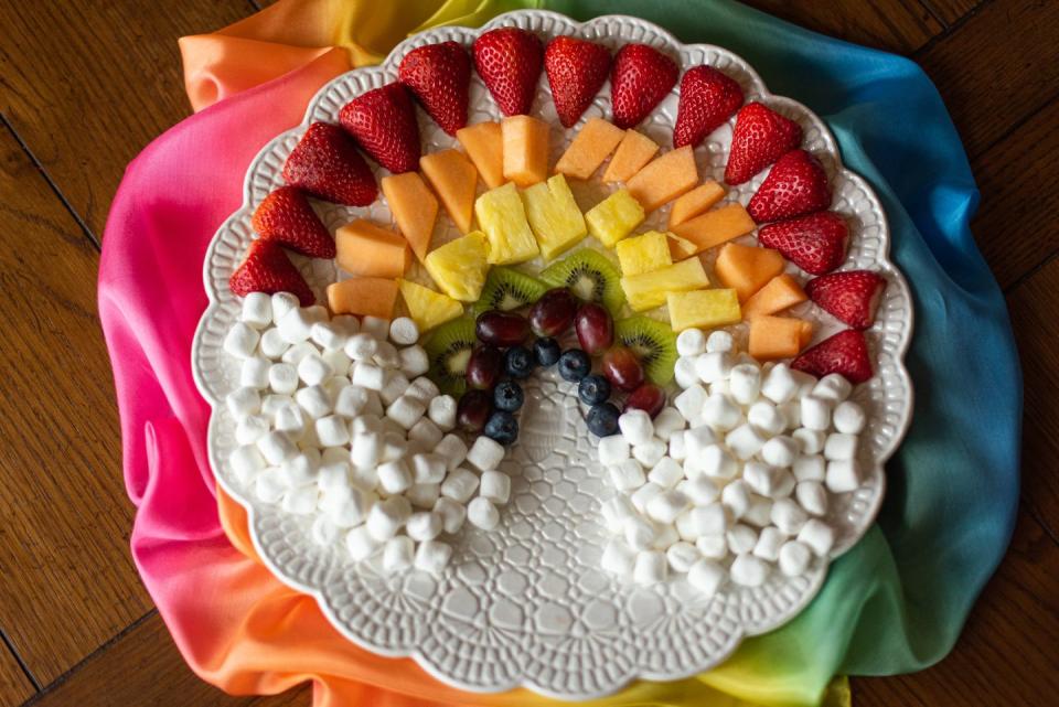 fruits and marshmallow arranged in a rainbow shape