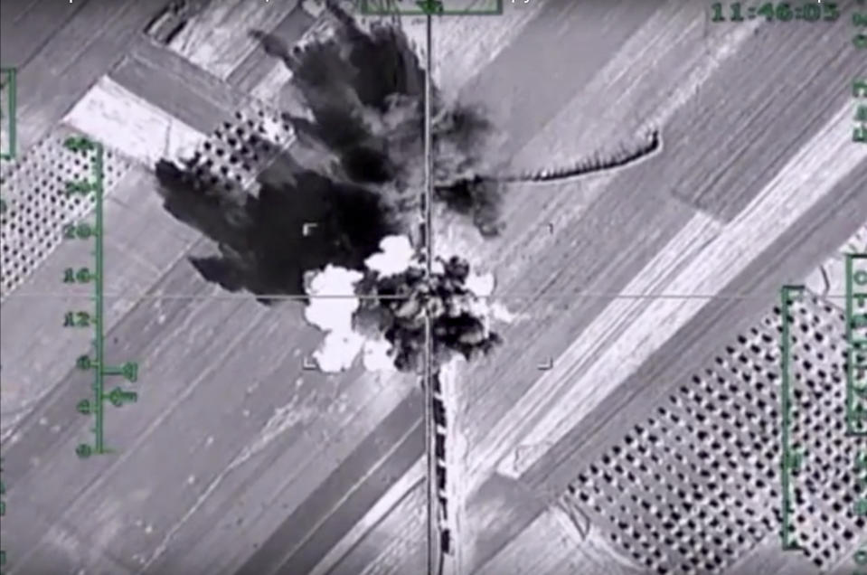 FILE - In this photo made from the footage taken from Russian Defense Ministry official web site on Feb. 1, 2016, an aerial image shows what it says is a column of heavy trucks carrying ammunition hit by a Russian air strike near Aleppo, Syria. Political observers say Russia’s brazen Syria intervention emboldened Putin, giving him a renewed Middle East foothold and helped pave the way for his current attack on Ukraine. (Russian Defense Ministry Press Service photo via AP, File)