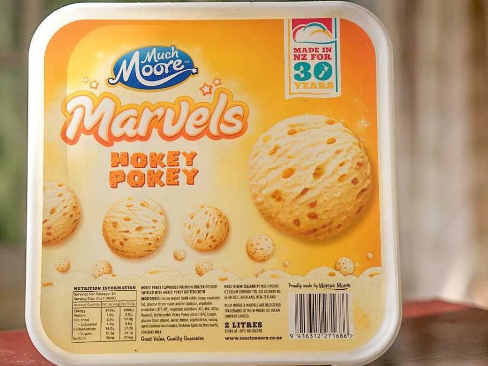 A yellow square-shaped box with illustrations of yellow ice cream with a blue "Much Moore" label and white and yellow lettering that says, "Marvels Hokey Pokey"