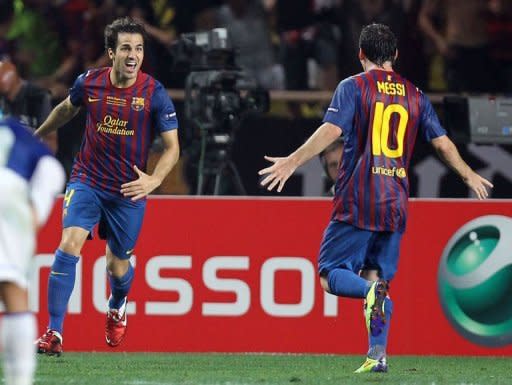 Barcelona's Spanish midfielder Cesc Fabregas (L) is congratulated by Lionel Messi during the UEFA Super Cup football match against FC Porto at the Louis II stadium in Monaco. Barcelona won 2-0