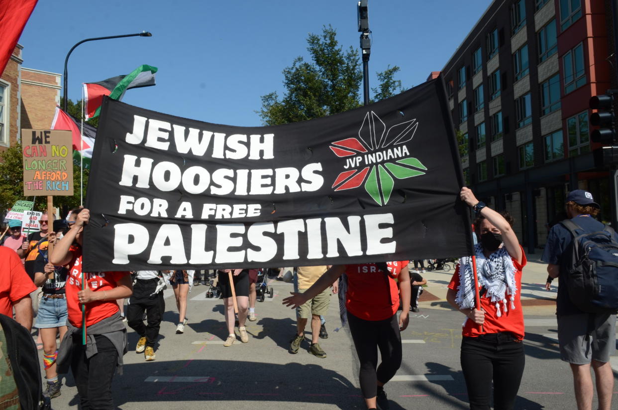 Several demonstrators hold a banner reading: Jewish Hoosiers for a free Palestine.