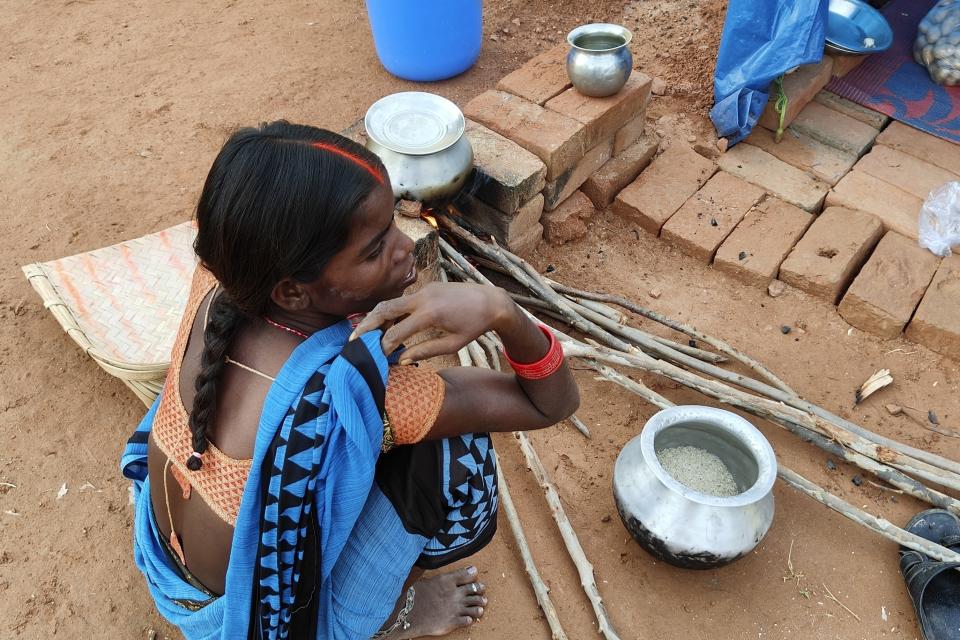 Babita Kumari cooks for her family in a brick kiln near her makeshift tent in Pilakhana village in Uttar Pradesh state, India, on Oct. 17, 2023. She has suffered two stillbirths that she attributed to the heavy lifting she endured daily in the brick kiln in scorching heat for long hours. (Uzmi Athar/Press Trust of India via AP)