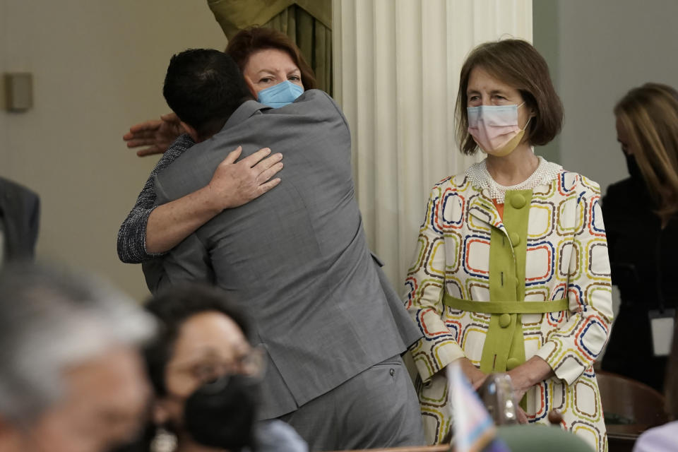 California Assembly Speaker Anthony Rendon hugs Senate President Pro Term Toni Atkins after lawmakers voted to put a constitution amendment on the November ballot that would guarantee the right to an abortion and contraceptives at the Capitol in Sacramento, Calif., Monday, June 27, 2022. The vote comes three days after the U.S. Supreme Court overruled Roe v. Wade. At right is state Sen. Nancy Skinner, D-Berkeley. (AP Photo/Rich Pedroncelli)