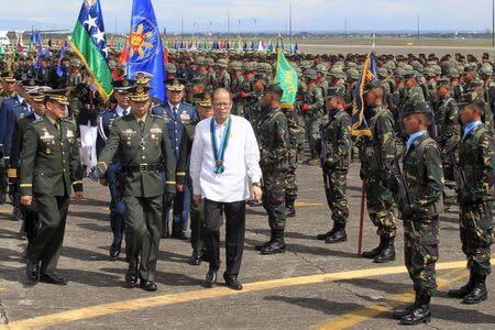 Philippines' President Benigno Aquino reviews a military platoon upon arrival during the 80th founding anniversary of the Armed Forces of the Philippines held inside Clark Air Base, formerly a U.S. base, in Angeles city, Pampanga province, north of Manila December 21, 2015. REUTERS/Romeo Ranoco