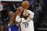 Sacramento Kings forward Harry Giles III left, and Memphis Grizzlies center Jonas Valanciunas, right, reach for a rebound during the first quarter of an NBA basketball game in Sacramento, Calif., Thursday, Feb. 20, 2020. (AP Photo/Rich Pedroncelli)