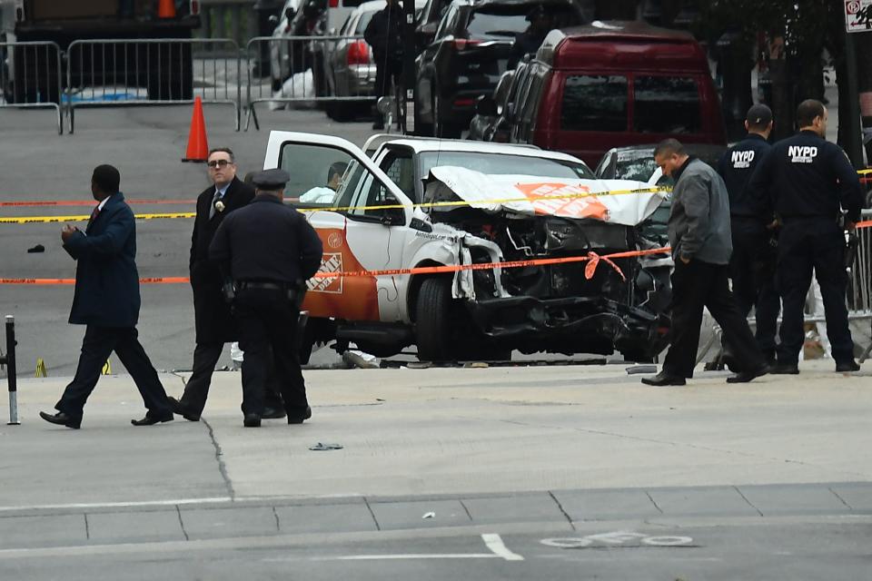 Investigators work around the wreckage of a Home Depot pickup truck a day after it was used in a terror attack in New York on November 1, 2017.&nbsp;