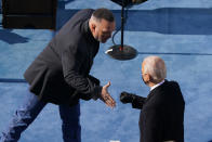 Country singer Garth Brooks reaches out to greet President Joe Biden during the 59th Presidential Inauguration at the U.S. Capitol in Washington, Wednesday, Jan. 20, 2021. (AP Photo/Susan Walsh, Pool)