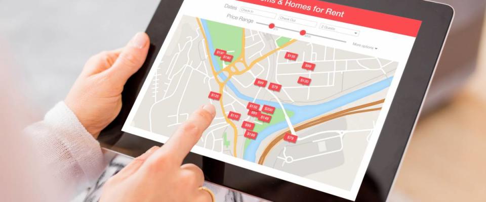 Person looking for places to stay on digital tablet app