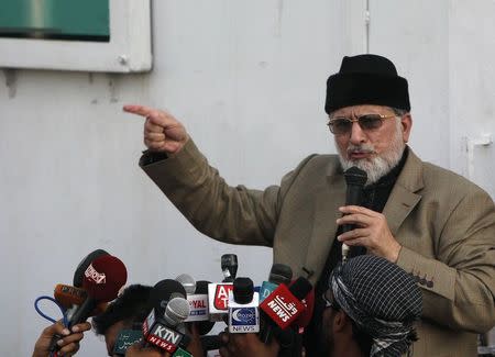 Mohammad Tahir ul-Qadri, Sufi cleric and leader of political party Pakistan Awami Tehreek, gestures as he addresses members of media outside the parliament house in Islamabad August 20, 2014. REUTERS/Akhtar Soomro