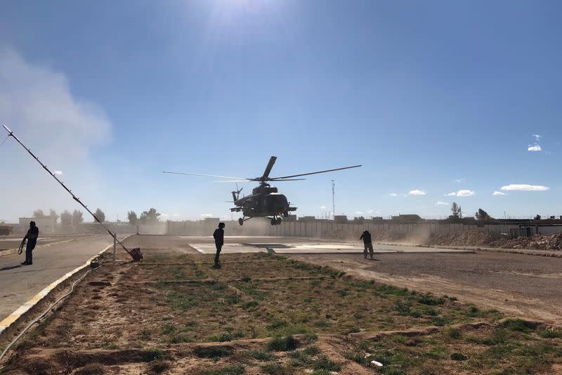 Iraqi army commanders visit by helicopter a military base near a border crossing with Syria at Al-Qaim