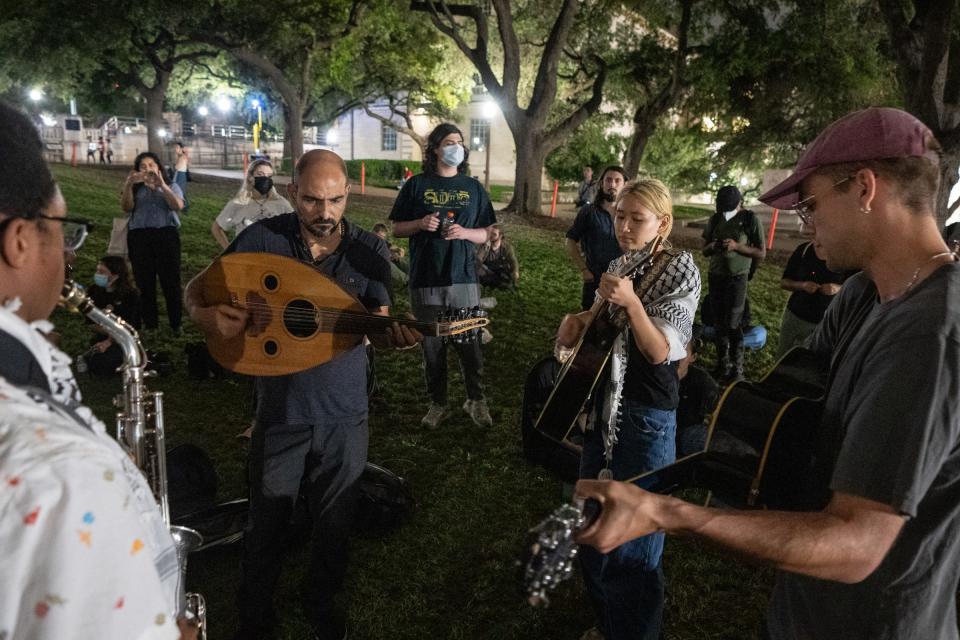 Protesters sing during a pro-Palestinian protest at the University of Texas Thursday, April 25, 2024.