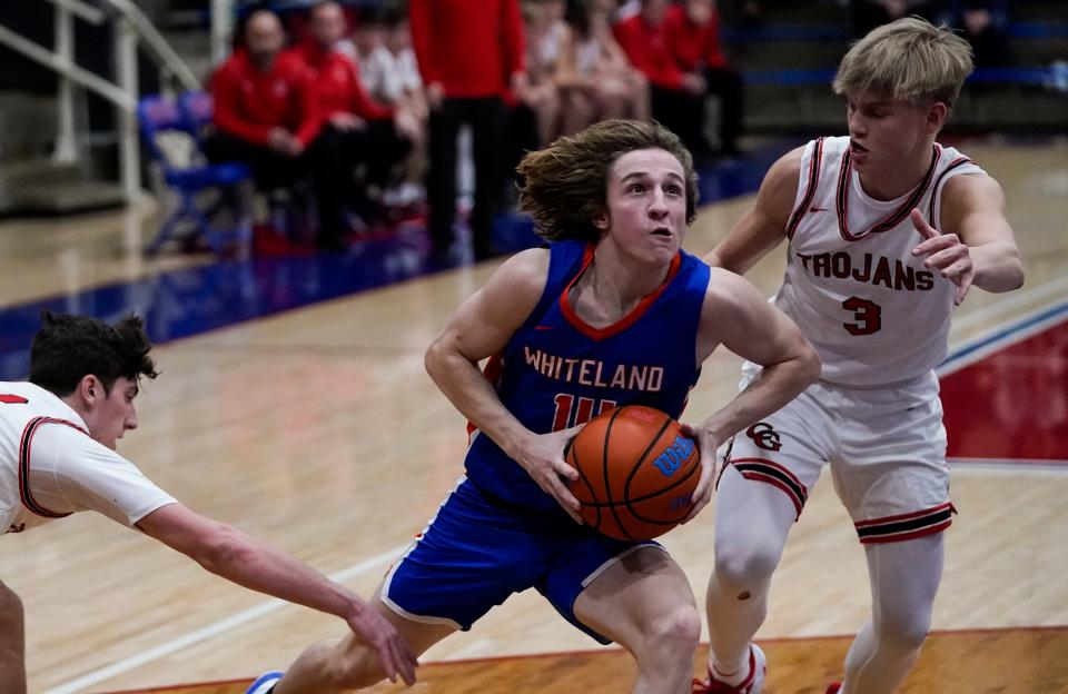 Whiteland guard Wiatt Mclaughlin (14) rushes past Center Grove Trojans guard Tyler Cerny (22) and Center Grove Trojans guard Marcus Ankney (3) on Saturday, Jan. 15, 2022, at Indian Creek High School in Trafalgar. Whiteland defeated the Center Grove Trojans in the Johnson County Championship game, 46-43. 