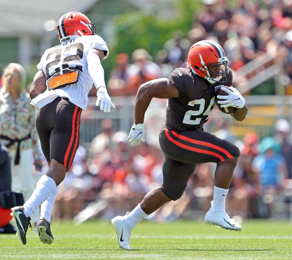 Cleveland Browns running back Nick Chubb, right, rushes past safety Grant Delpit during the NFL football team's football training camp in Berea on Tuesday.