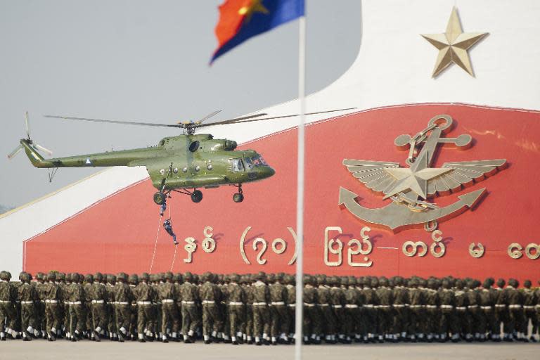 Myanmar Navy Seals descend from a helicopter during a ceremony to mark the 70th anniversary of Armed Forces Day in Myanmar's capital Naypyidaw on March 27, 2015