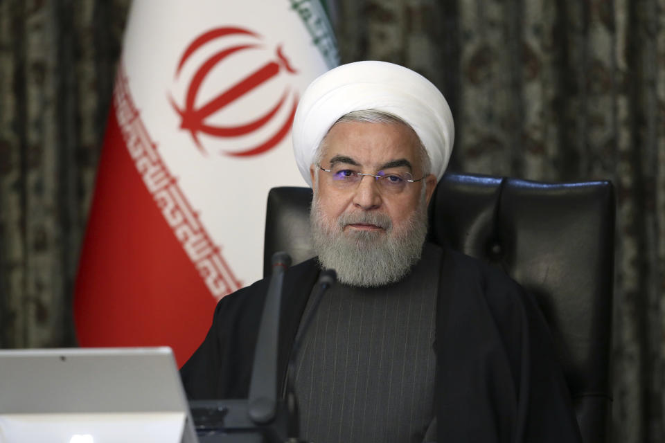 In this photo released by the official website of the Office of the Iranian Presidency, President Hassan Rouhani attends a cabinet meeting in Tehran, Iran, Wednesday, March 18, 2020. Iran has been the hardest hit country by the new coronavirus in the Middle East. For most people, the new coronavirus causes only mild or moderate symptoms. For some it can cause more severe illness. (Office of the Iranian Presidency via AP)