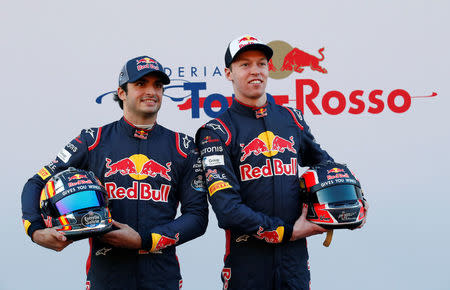 Spain Formula One - F1 - 2017 Toro Rosso STR12 Formula One Car Launch - Barcelona-Catalunya racetrack in Montmelo - 26/2/17. Toro Rosso's drivers Daniil Kvyat (R) and Carlos Sainz pose during the presentation of the new STR12 racing car. REUTERS/Albert Gea