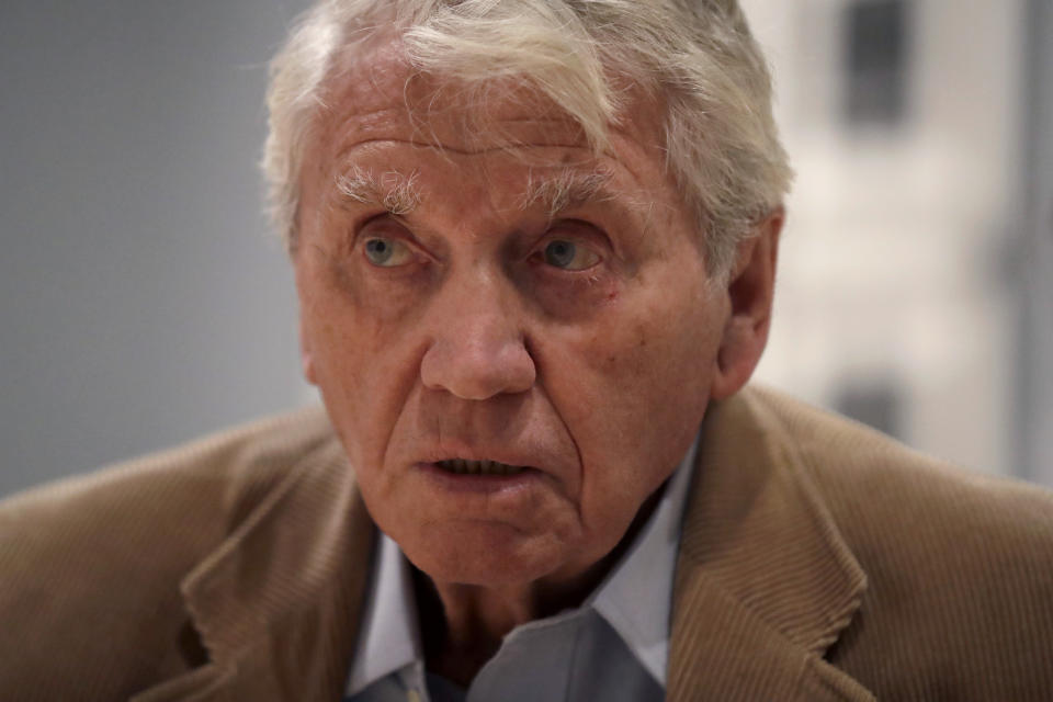 Veteran British conflict photographer Don McCullin speaks during an interview with The Associated Press at the launch of his retrospective exhibition at the Tate Britain gallery in London, Monday, Feb. 4, 2019. The exhibition includes over 250 of his black and white photographs, including conflict images from the Vietnam war, Northern Ireland, Cyprus, Lebanon and Biafra, alongside landscape and still life images. (AP Photo/Matt Dunham)