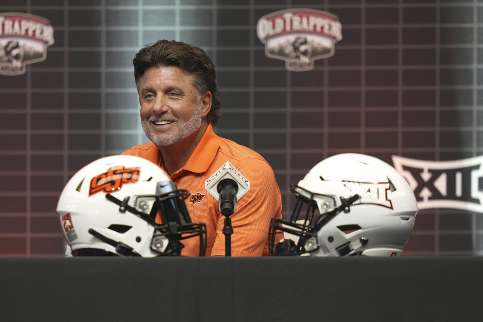 Oklahoma State head football coach Mike Gundy jokingly begins to stand after no questions were initially asked of him at the NCAA college football Big 12 media days in Arlington, Texas, Wednesday, July 12, 2023. (AP Photo/LM Otero)