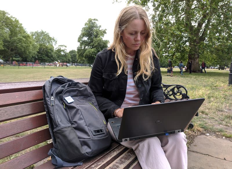 Dyson design engineer Rowley examines data on her laptop on Clapham Common, London