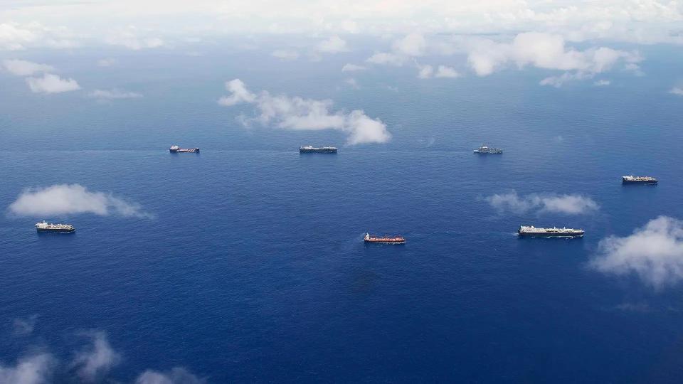 Various US Navy at-sea-replenishment and sealift ships sail in formation.<em> USN</em>