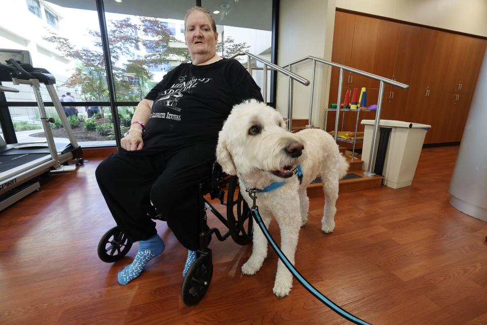 Christine Crandall looks at Cooper, a therapy dog, at St. Marks Hospital in Salt Lake City on Monday, June 12, 2023. The canine therapy program is resuming following COVID-19. | Scott G Winterton, Deseret News
