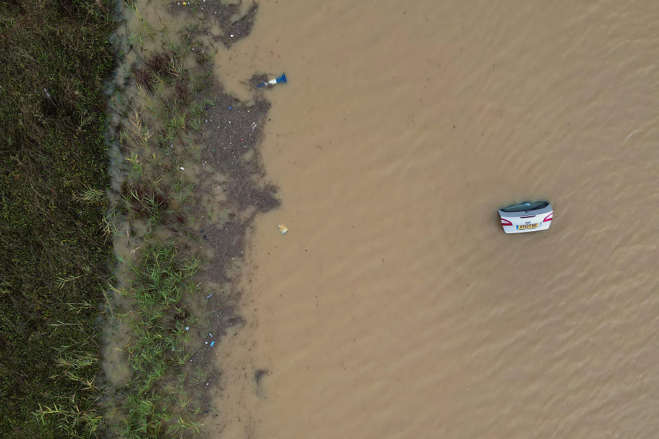 The open boot of a car is visible above the water where the vehicle is submerged in flood water on a421 in Marston Moretaine, Bedfordshire. Parts of Britain have been struck by flash floods after some areas saw more than a month's worth of rain in 24 hours. Heavy rainfall has seen parts of Northamptonshire, Bedfordshire and London submerged causing widespread travel disruption and damage to properties. Picture date: Monday September 23, 2024. (Photo by Joe Giddens/PA Images via Getty Images)